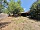 Large, partially fenced yard with mature trees and grass at 4621 Queens Point Drive, Lakeland, FL 33813