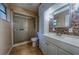Bathroom with a tiled walk-in shower, a vanity with storage and a mirror at 4621 Queens Point Drive, Lakeland, FL 33813