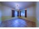 Dining room featuring tile flooring, two windows, and a chandelier at 4621 Queens Point Drive, Lakeland, FL 33813