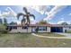 Charming single-story home with a well-maintained lawn and a mature palm tree in the front yard at 4621 Queens Point Drive, Lakeland, FL 33813