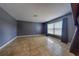 Spacious living room featuring tile floors, neutral walls, and a window with blinds at 4621 Queens Point Drive, Lakeland, FL 33813