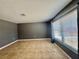 Bright living room with a large window and neutral tile flooring at 4621 Queens Point Drive, Lakeland, FL 33813