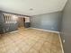 Open-concept living room with neutral tile flooring and stylish decorative railing at 4621 Queens Point Drive, Lakeland, FL 33813