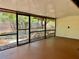 A partially enclosed patio, featuring concrete flooring and a view of the backyard at 4621 Queens Point Drive, Lakeland, FL 33813