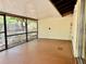 A partially enclosed patio with concrete flooring and a view of the backyard at 4621 Queens Point Drive, Lakeland, FL 33813