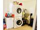 A laundry room featuring a stacked washer/dryer, storage cabinet, and hanging rack, designed for efficiency at 4746 Wales St, Lake Wales, FL 33859