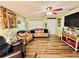 Cozy living room with hardwood floors, comfortable seating, ceiling fan and bright natural light at 4746 Wales St, Lake Wales, FL 33859