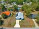 Aerial view of property lines, a home with solar panels, and surrounding landscaping at 12164 Se 85Th Ct, Belleview, FL 34420