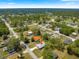 Aerial view of a home in a lush residential area surrounded by mature trees on a sunny day at 12164 Se 85Th Ct, Belleview, FL 34420