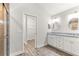 Bathroom featuring double vanity, granite countertops, and walk-in closet at 12164 Se 85Th Ct, Belleview, FL 34420
