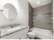 Bathroom features a vanity with granite countertop, tiled shower over tub, and modern fixtures at 12164 Se 85Th Ct, Belleview, FL 34420