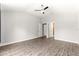 Spacious bedroom features a ceiling fan, multiple closets and wood-look laminate flooring at 12164 Se 85Th Ct, Belleview, FL 34420