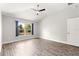 Bedroom with a large window with backyard views and neutral color palette at 12164 Se 85Th Ct, Belleview, FL 34420