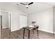 Bright bedroom boasts wood-look floors, a ceiling fan, closet, and neutral decor at 12164 Se 85Th Ct, Belleview, FL 34420