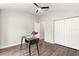 Bedroom showcases wood-look floors, a ceiling fan, closet, and minimalist decor at 12164 Se 85Th Ct, Belleview, FL 34420