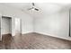 Bedroom featuring wood-look floors, ceiling fan, and interior door at 12164 Se 85Th Ct, Belleview, FL 34420