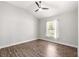 Bedroom with wood-look floors, a ceiling fan, and a sunlit window at 12164 Se 85Th Ct, Belleview, FL 34420