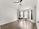 Bright bedroom featuring wood-look floors, a ceiling fan, and a bay window nook at 12164 Se 85Th Ct, Belleview, FL 34420