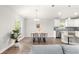 Cozy dining area with stylish chairs, a modern chandelier, and bright natural light at 12164 Se 85Th Ct, Belleview, FL 34420