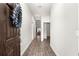 Inviting entryway with wood-look flooring, white walls, and a decorated front door wreath at 12164 Se 85Th Ct, Belleview, FL 34420
