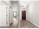 A view of the home's entryway with hardwood floors, a decorative light fixture, and light gray walls at 12164 Se 85Th Ct, Belleview, FL 34420