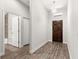 Entryway featuring hardwood-style floors and leading to a bathroom and wood-finished front door at 12164 Se 85Th Ct, Belleview, FL 34420
