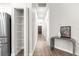 Bright hallway showcasing a pantry, decorative table, and a dark wood front door at 12164 Se 85Th Ct, Belleview, FL 34420