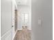 Hallway view of tiled shower and walk-in closet in neutral color palette at 12164 Se 85Th Ct, Belleview, FL 34420
