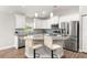 Well-lit kitchen with granite countertops, stainless steel appliances, and a breakfast bar at 12164 Se 85Th Ct, Belleview, FL 34420
