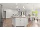 Open-concept kitchen view featuring a breakfast bar, dining area, and living room at 12164 Se 85Th Ct, Belleview, FL 34420