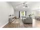 Cozy living room featuring a ceiling fan and access to the backyard at 12164 Se 85Th Ct, Belleview, FL 34420