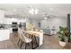 Open floor plan featuring a modern kitchen, dining area, and living room with wood flooring at 12164 Se 85Th Ct, Belleview, FL 34420