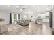 Spacious living area with modern furnishings, kitchen bar, and sliding glass doors to backyard at 12164 Se 85Th Ct, Belleview, FL 34420