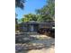 Cozy single story home features a simple front facade, white door, and new grey roof at 332 W 8Th St, Lakeland, FL 33805