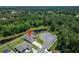 Aerial view of the property and neighborhood, showing a home with a pool situated near a pond at 5419 Knights Landing Dr, Lakeland, FL 33810