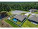 Aerial view of a home with pool, showcasing its backyard, neighborhood, and wooded surroundings at 5419 Knights Landing Dr, Lakeland, FL 33810