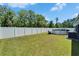 Backyard view of pool and grassy yard with perimeter fencing at 5419 Knights Landing Dr, Lakeland, FL 33810