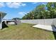 Picture of the backyard featuring a well-maintained lawn, pool with staircase, and perimeter fencing at 5419 Knights Landing Dr, Lakeland, FL 33810