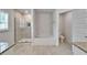 Bright bathroom featuring a walk-in shower, soaking tub, and modern fixtures at 5419 Knights Landing Dr, Lakeland, FL 33810