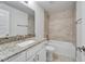 Bathroom features a sink with granite countertop and a tiled bathtub at 5419 Knights Landing Dr, Lakeland, FL 33810