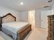 Neutral bedroom with a large, wooden-framed bed and plush carpeting at 5419 Knights Landing Dr, Lakeland, FL 33810