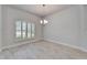 Bright dining room featuring tile flooring, large window and modern chandelier at 5419 Knights Landing Dr, Lakeland, FL 33810