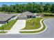 Beautifully landscaped home with a spacious driveway, well-maintained lawn, and a charming pond view at 5419 Knights Landing Dr, Lakeland, FL 33810