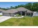 Charming home featuring a well-manicured lawn, beautifully landscaped front yard, and a two-car garage at 5419 Knights Landing Dr, Lakeland, FL 33810