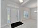 Bright foyer featuring a white front door, sidelights, transom window, and wood-look tile flooring at 5419 Knights Landing Dr, Lakeland, FL 33810