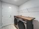 Laundry room with modern washer and dryer, and a wooden countertop at 5419 Knights Landing Dr, Lakeland, FL 33810