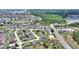 Aerial view of the community, showcasing homes, a pond, and the surrounding natural landscape at 634 Canna Dr, Davenport, FL 33897