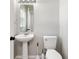 Bright half-bathroom featuring a pedestal sink and a clean, minimalist design at 634 Canna Dr, Davenport, FL 33897