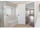 Bathroom featuring bathtub and glass-enclosed shower, and view to bedroom at 634 Canna Dr, Davenport, FL 33897