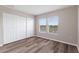 Cozy bedroom features wood-look floors, closet, and natural lighting at 634 Canna Dr, Davenport, FL 33897